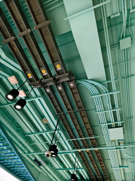 istock Ceiling with ventilation pipes and lights in industrial building 2166331608