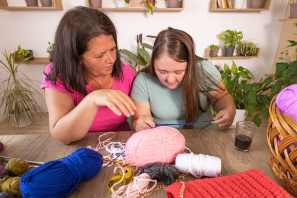 istock Mother Teaches Knitting 2166333269