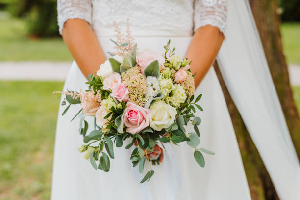 istock Wedding bouquet in hands of the bride 2166336674