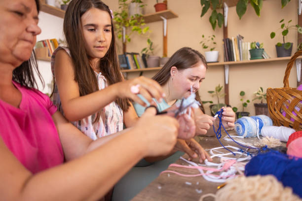 istock Mom Teaches Knitting 2166338296