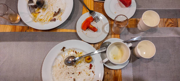 istock The leftover food and dirty empty dishes on the restaurant table. 2166341186