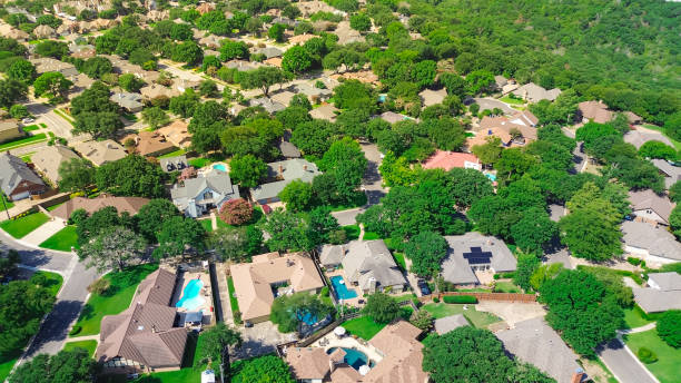 istock Solar roof panels, greenspace, urban forest, environmentally friendly practices in zero emission neighborhood suburbs Dallas Fort Worth Metroplex, lush green trees swimming pool houses, aerial 2166342289