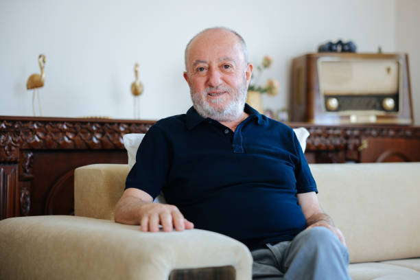 istock Smiling mature man sitting on her living room sofa 2166342954