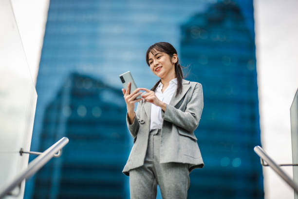 istock Businesswoman using phone in financial district 2166346964