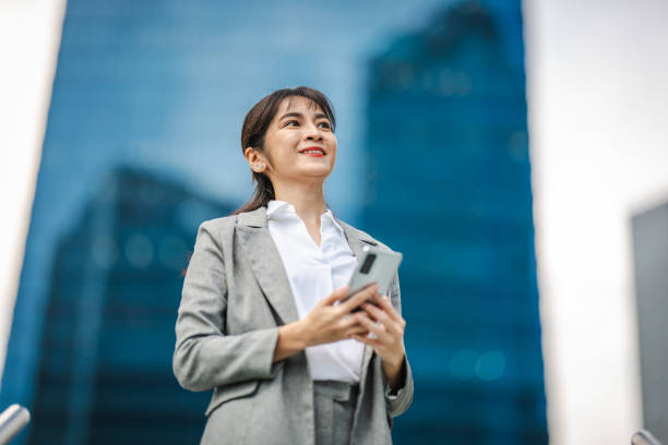 istock Empowering Success: A Businesswoman's Journey Through the Financial District, Connected by Technology 2166347214
