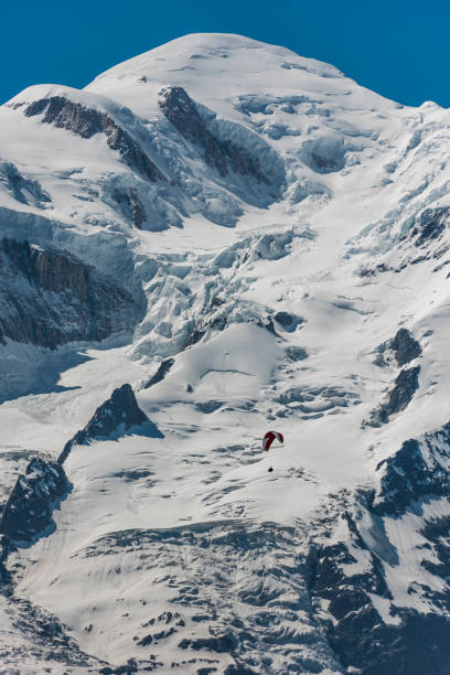 Paragliding below summit of Mont Blanc, Chamonix, Haute-Savoie, French Alps, France