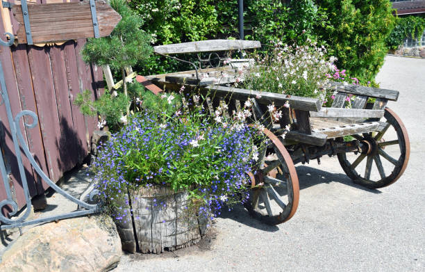 istock Decorative rustic flower arrangement with old wooden carriage 2166349593
