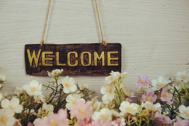 istock Welcome sign Hanging on grunge cement wall background 2166350331