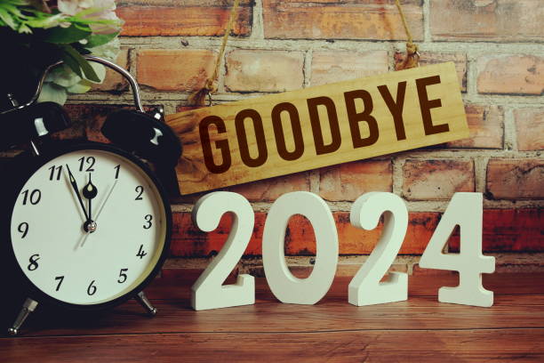 istock Goodbye 2024 letters with alarm clock on wooden background 2166350534