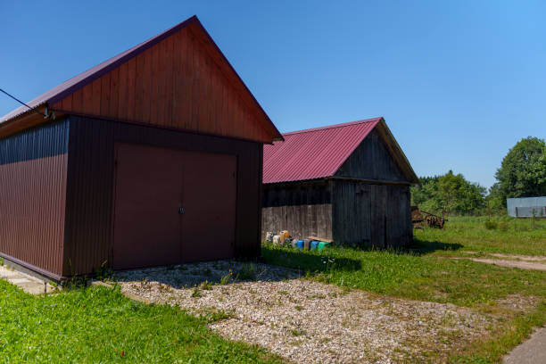 istock Two barns in a sunny rural backyard 2166350797