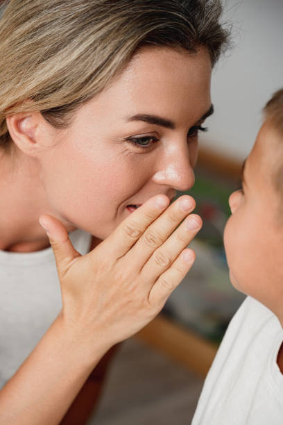 istock Happy Mother and her Little Son Sharing Secrets at Home 2166350913