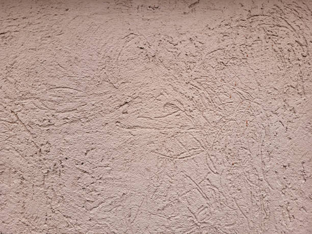 The background of a beautiful pink decorative plaster bark beetle.