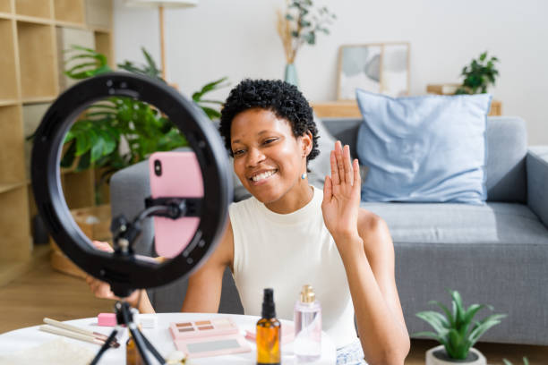 istock Beauty blogger is waving to followers while recording makeup tutorial 2166353436