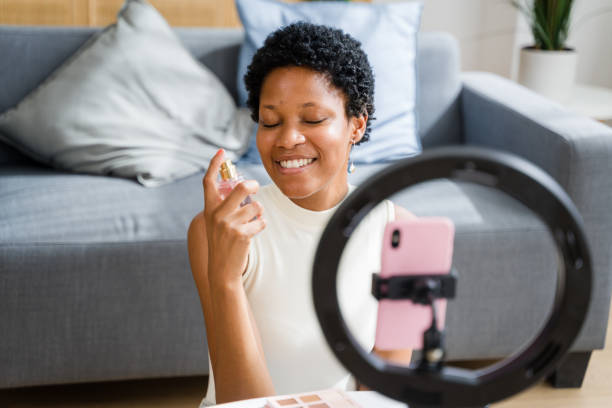 istock Beauty influencer applying perfume while recording video with smartphone 2166353502