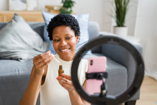 istock Influencer showing essential oil during live video 2166353520