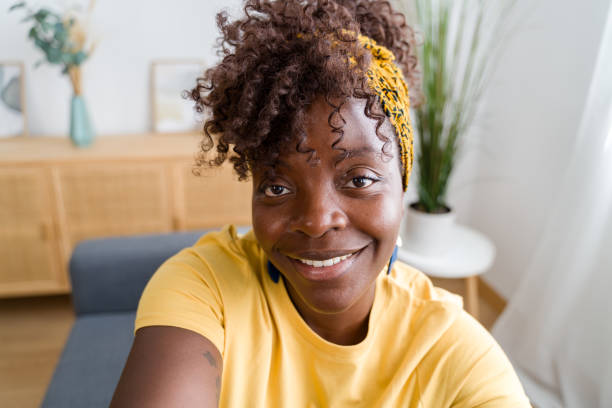istock Beautiful woman smiling while taking a selfie at home 2166355607