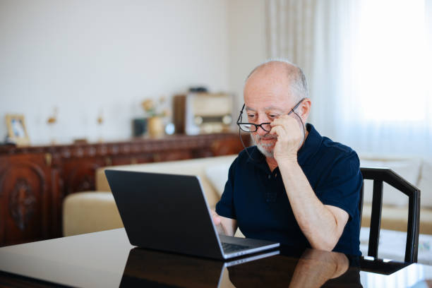 istock Happy smiling senior man with laptop 2166358741