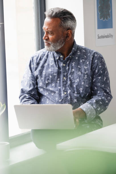 istock Male business professional using laptop 2166360449