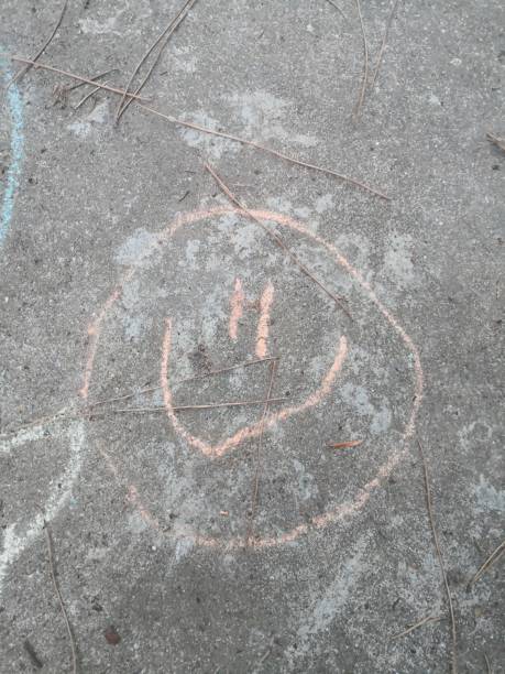 istock Child chalk drawing smiley face 2166362317