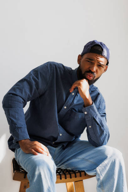 istock Bearded african american man in snapback grimacing on grey background 2166363029
