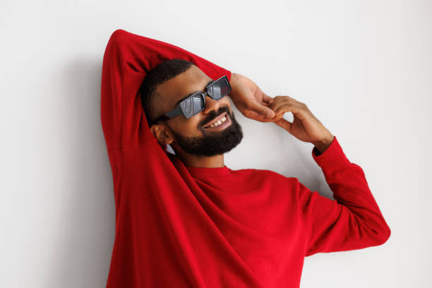 istock Smiling african american man in sunglasses and red pullover on grey background 2166363342