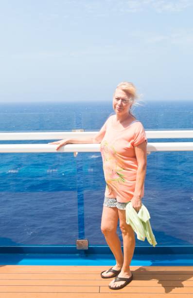istock Blonde woman posing on deck of a ship 2166366294