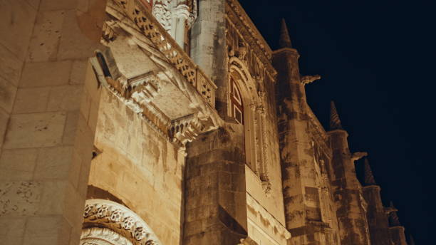 istock Illuminated gothic architecture historic church at night. Stone building facade 2166366336