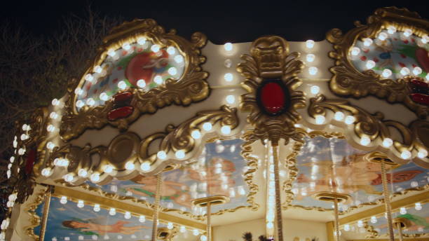 istock Beautiful carousel glowing lights at night festive scene. Bright roundabout 2166366428