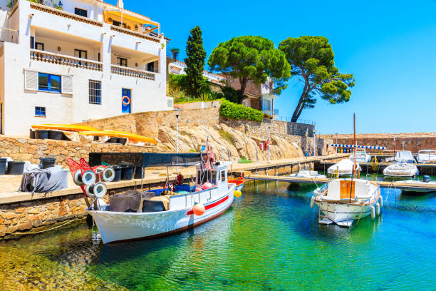 Fishing boats in picturesque port of Fornells village, Costa Brava, Spain stock photo