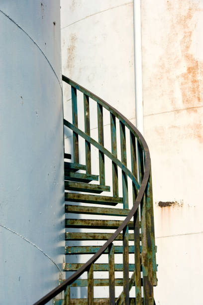 istock Large industrial cylinder storage tanks and spiral staircase 2166369645