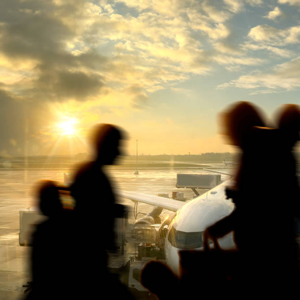 istock Passengers in airport departure area during sunset 2166371092
