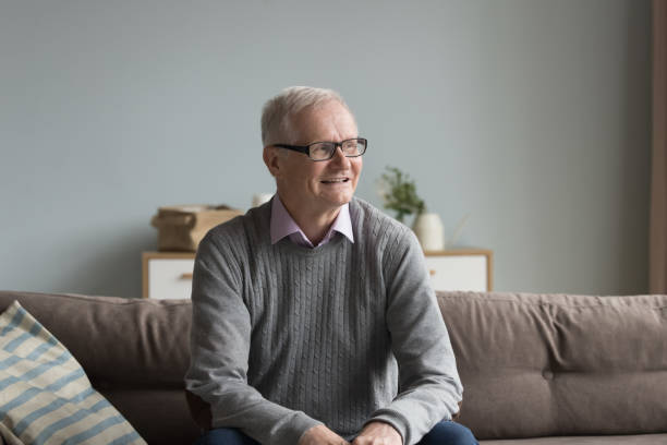 istock Hoary senior man sits on couch relaxing alone at home 2166371097