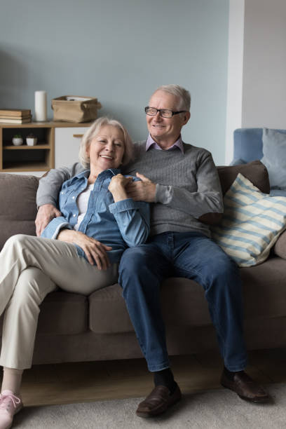 istock Senior couple resting and talking on sofa at home 2166371648