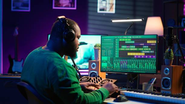 istock African american music producer twisting knobs on mixing console 2166371950