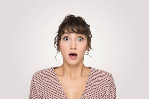 istock Captivating Close-Up Young Woman's Startled Expression in Casual Striped Attire 2166373006