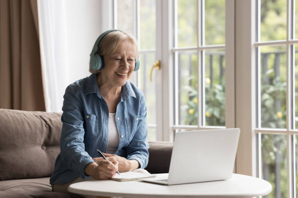 istock Happy older lady improves skills remotely use online classes 2166374487