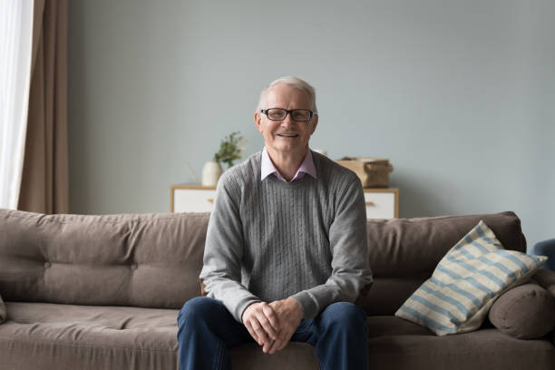 istock Calm retired elderly man resting seated on comfortable couch 2166375795