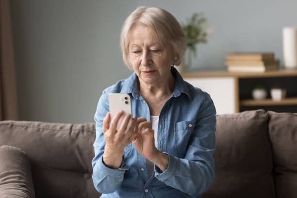 istock Focused woman read sms on cell phone 2166376086