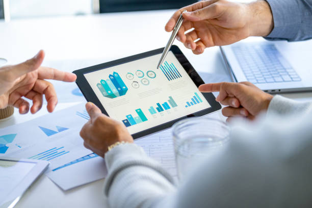 istock Three  business men meeting and looking at financial data, charts and graphs on a digital tablet. 2166379357