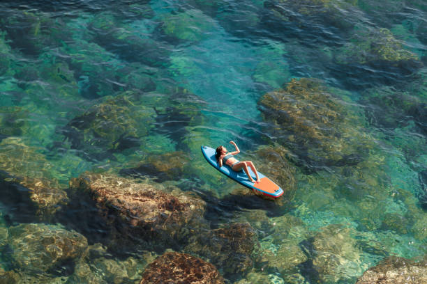 istock Enjoying the paddle board at sea 2166381736