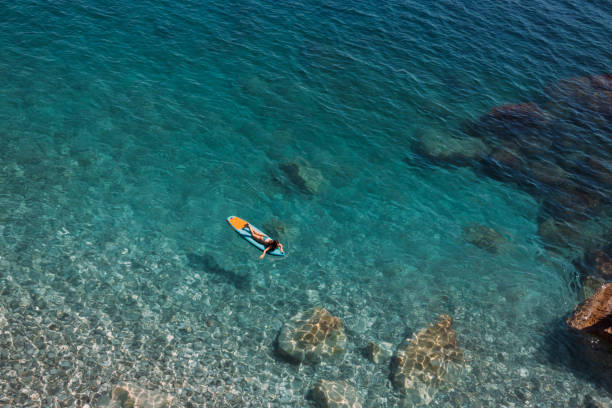 istock Enjoying the paddle board at sea 2166381741