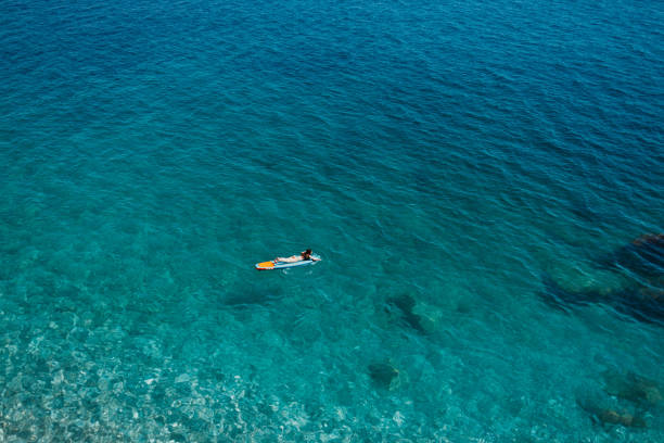 istock Enjoying the paddle board at sea 2166381742