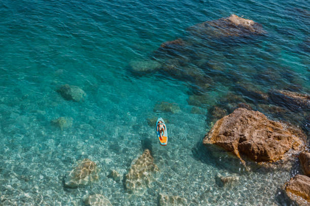 istock Enjoying the paddle board at sea 2166381750