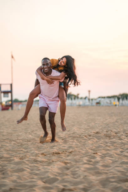 istock Handsome Young Multiracial Couple On A Sandy Beach 2166383498
