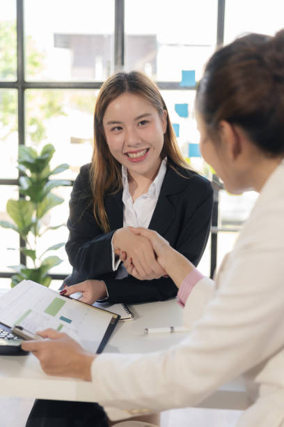istock Interviewer holding hands for job interview Greeting agreement concept Two happy Asian businesswomen holding hands to congratulate on successful work, congratulate on business deal. 2166384781