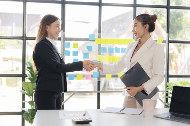 istock Interviewer holding hands for job interview Greeting agreement concept Two happy Asian businesswomen holding hands to congratulate on successful work, congratulate on business deal. 2166384792