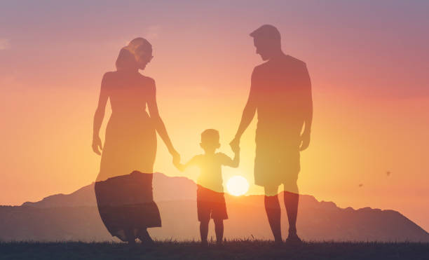 istock Happy family at sunset. 2166389542
