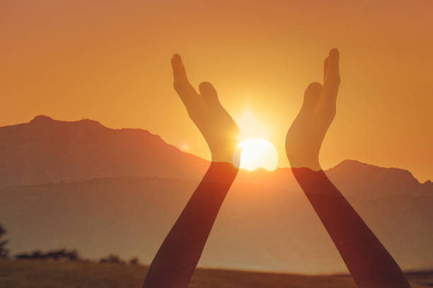 istock Woman touching sun in her hands. 2166389548