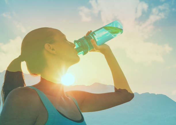 istock Woman drinking water in hot summer day. 2166389775