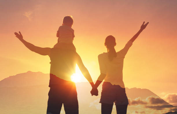 istock Happy family at sunset. 2166389858